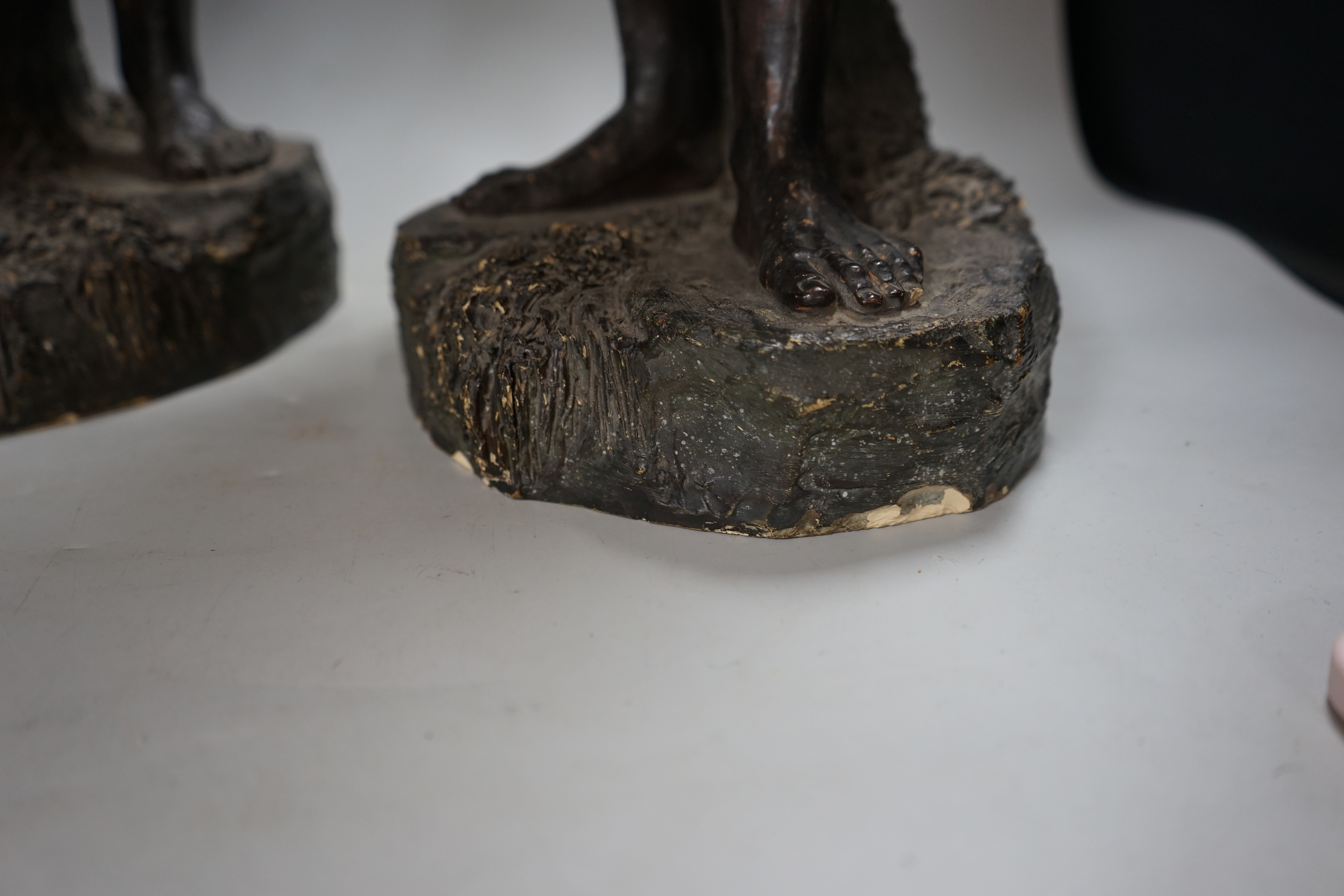 A pair of Continental painted pottery figures of Nubian water carriers, tallest 89cm high
